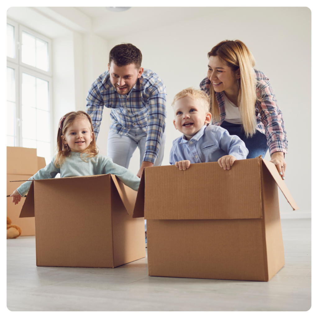 family playing with kids in moving boxes